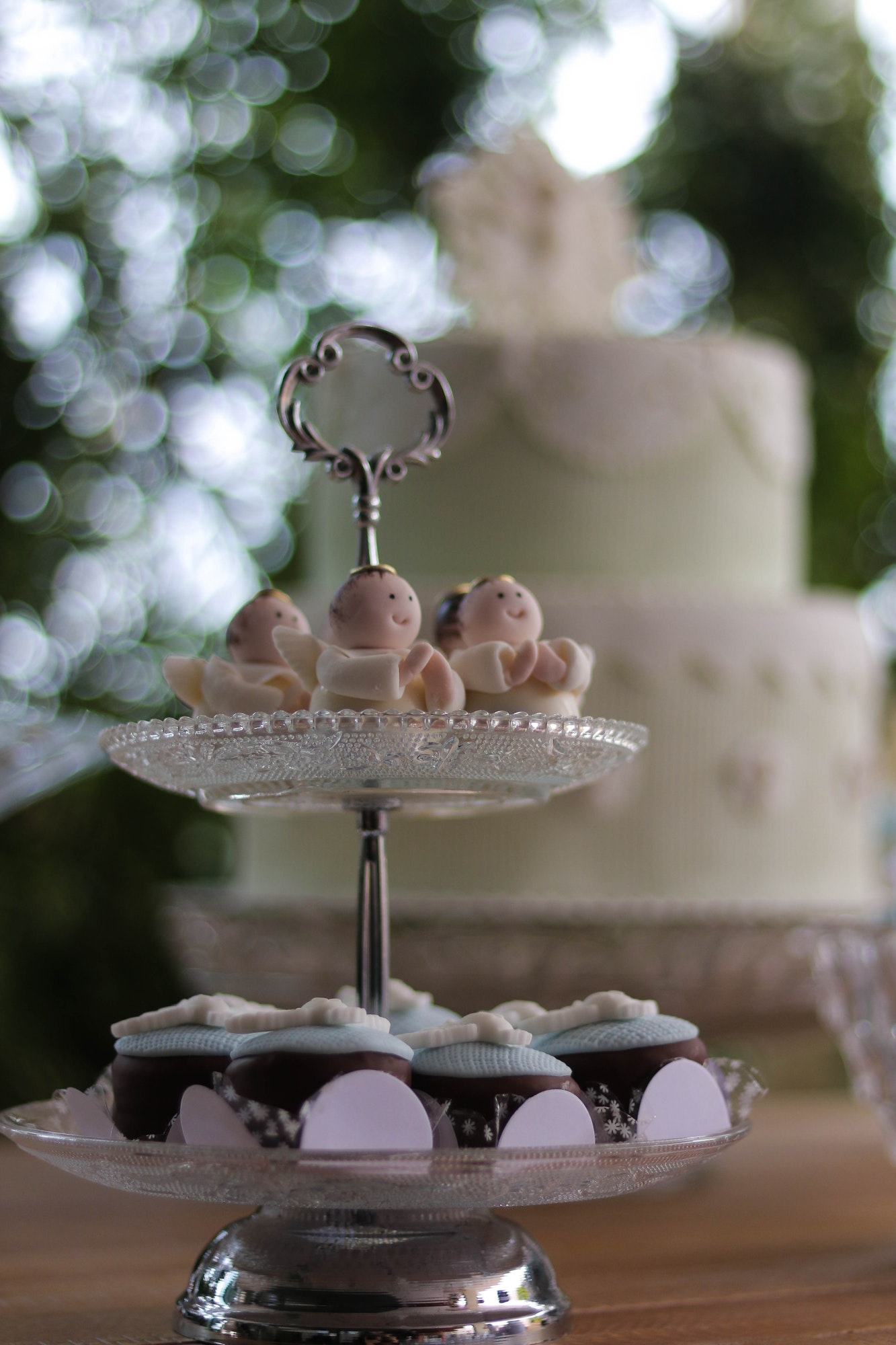 sweets and decorations from a christening party with a cake in depth of field as background